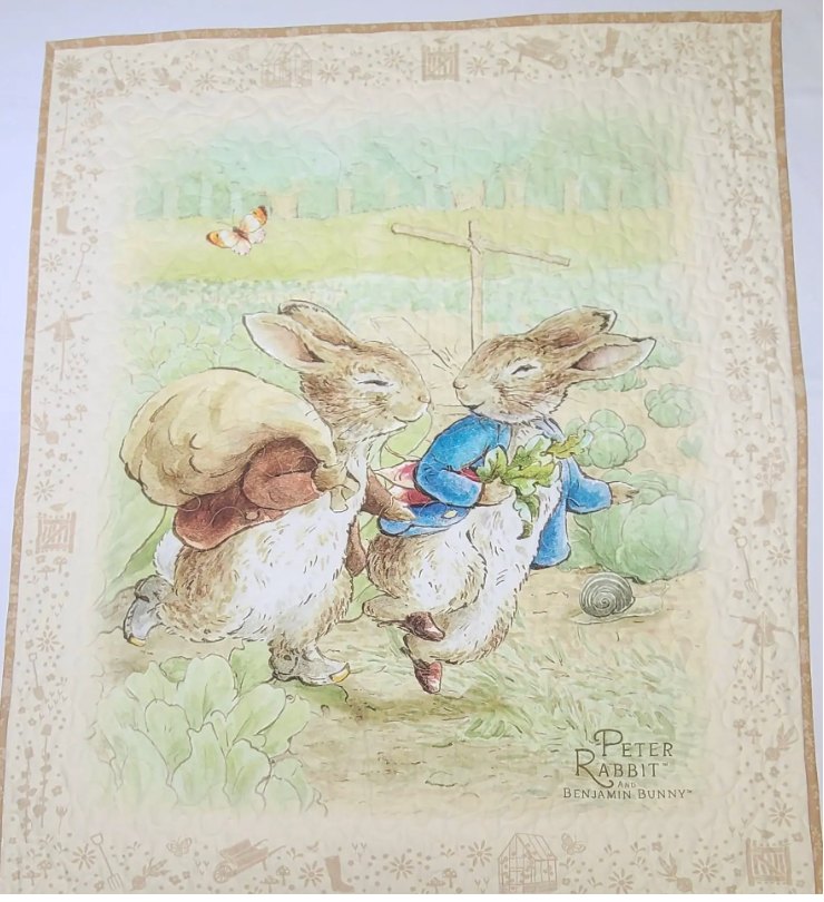 Quilt kit panel of two rabbits with a snail, featuring the text 'Peter Rabbit' by Benjamin Rabier.
